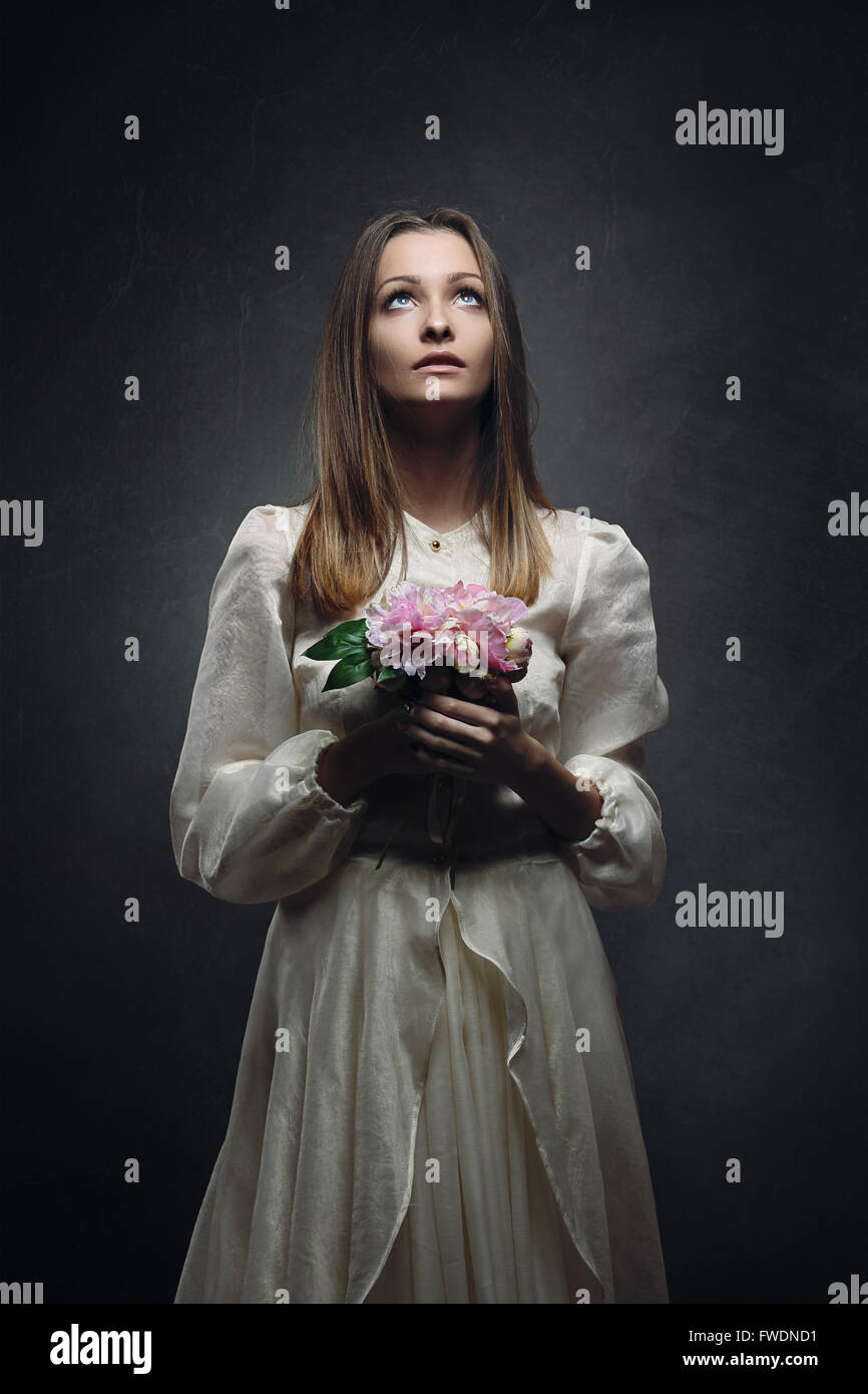 Woman with victorian bride dress and innocent eyes to the sky Stock Photo