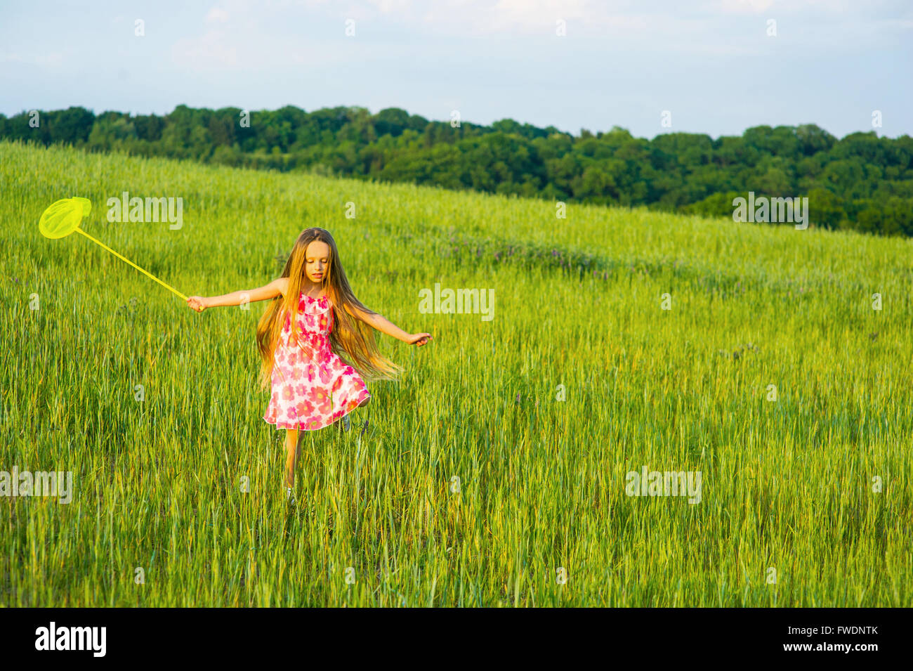 Little girl playing in the grass Stock Photo - Alamy