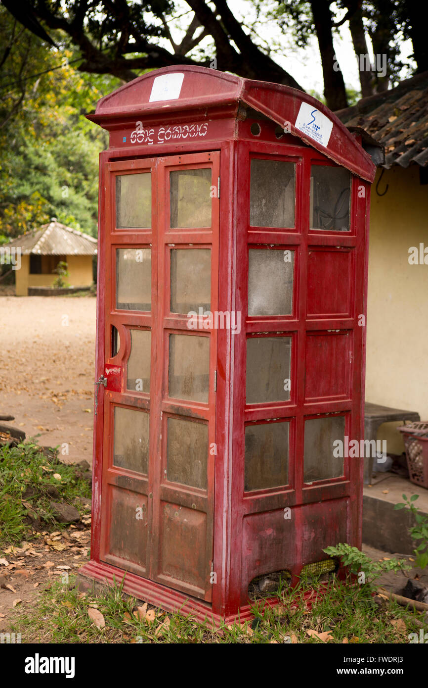 Sri Lanka, Polonnaruwa, quadrangle, broken red public call telephone box; Stock Photo