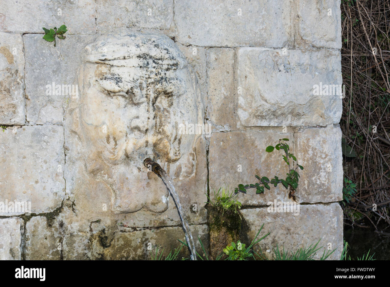 Fountain with sculpture on the wall. Typical of the Sicilian countryside. Typical of the province of Ragusa, places of Montalban Stock Photo