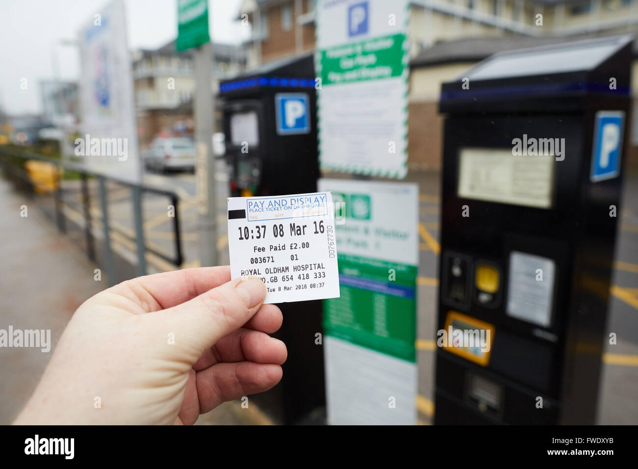 Oldham Royal Pennine Acute Hospitals NHS Trust parking ticket in hand Stock Photo