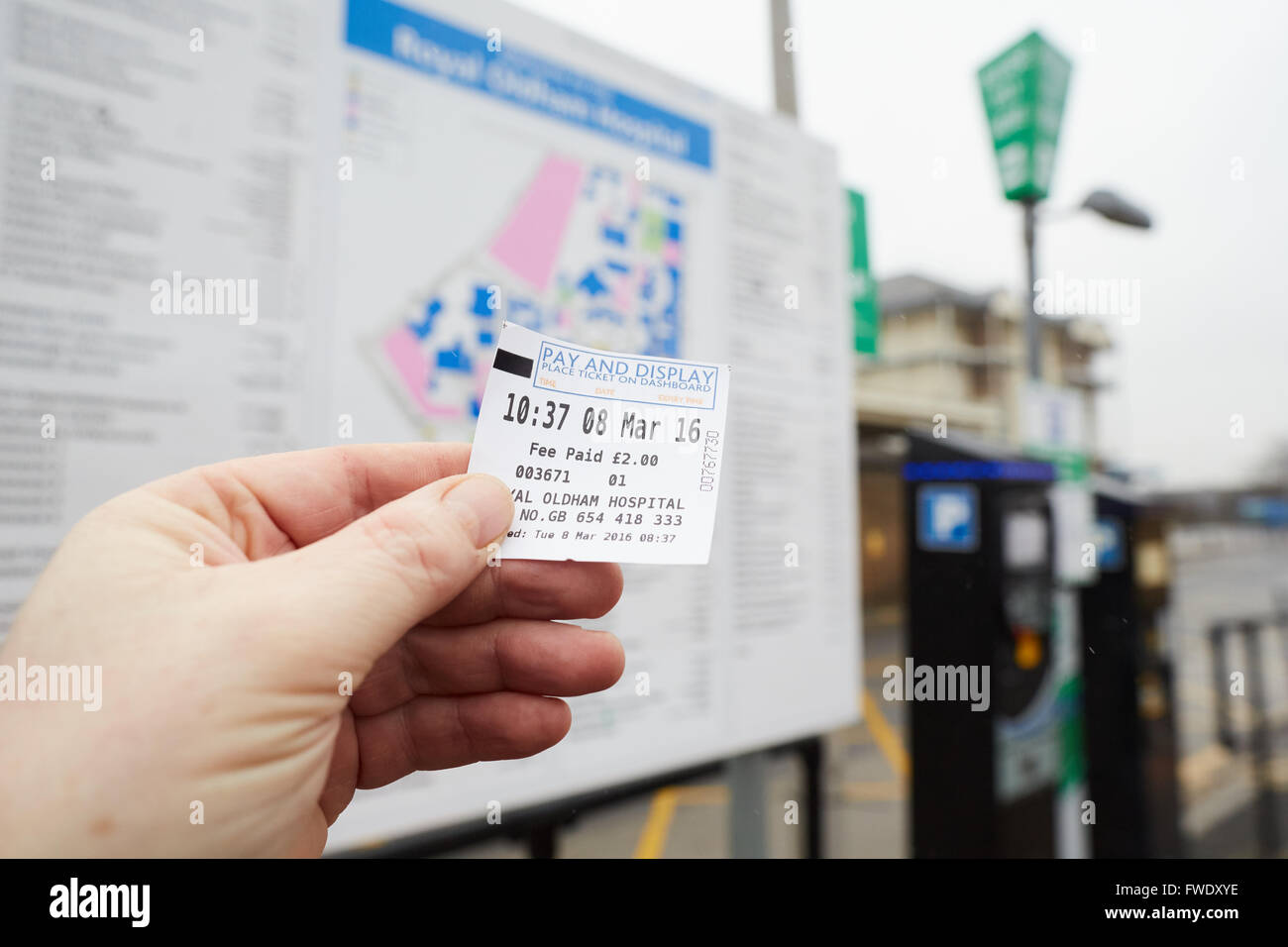 Oldham Royal Pennine Acute Hospitals NHS Trust parking ticket in hand Stock Photo