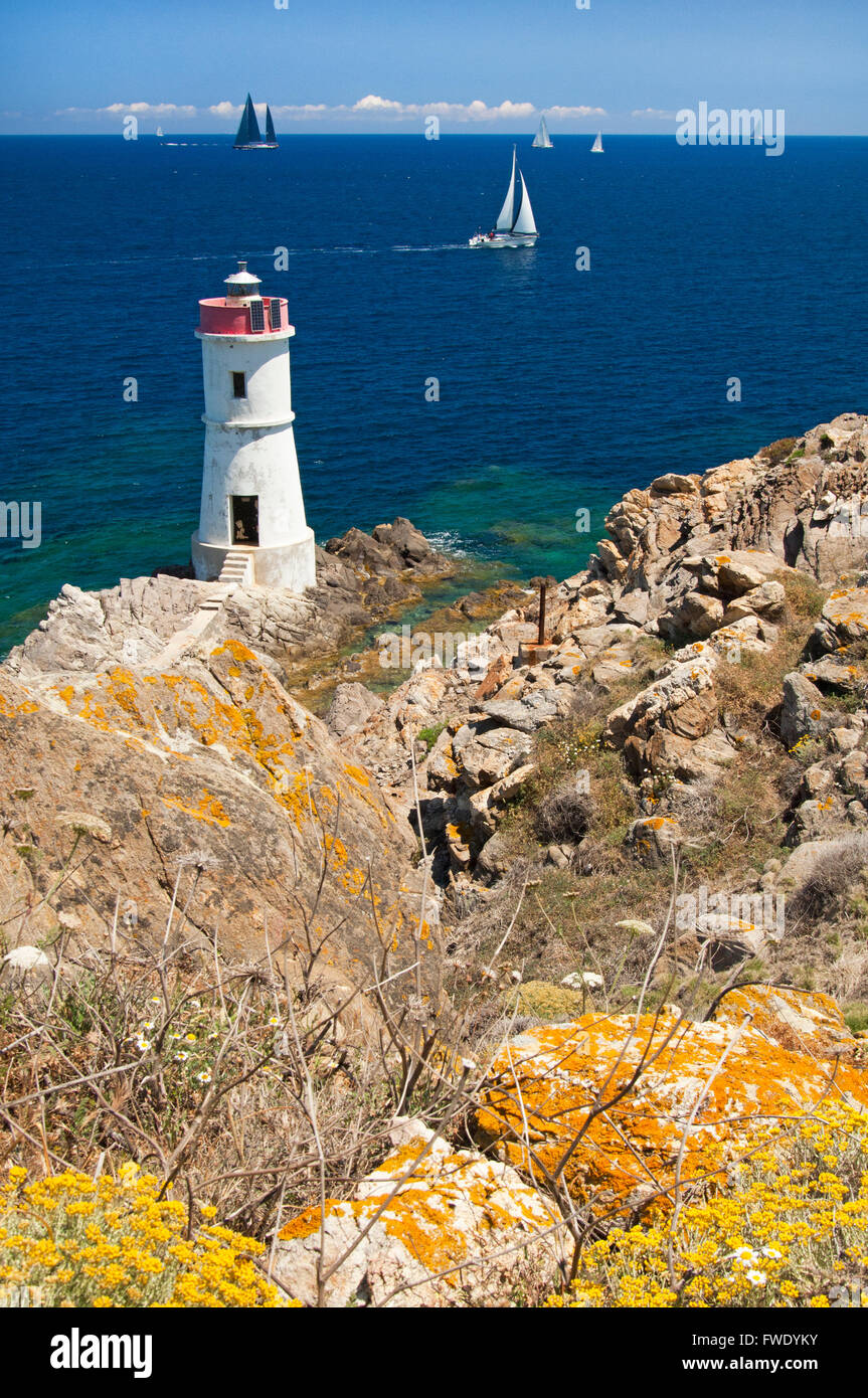 Emerald coast,Sardinia,Italy, 5/2014.Yachts sailing the coast and lighthouse near Porto Cervo, Arzachena Stock Photo