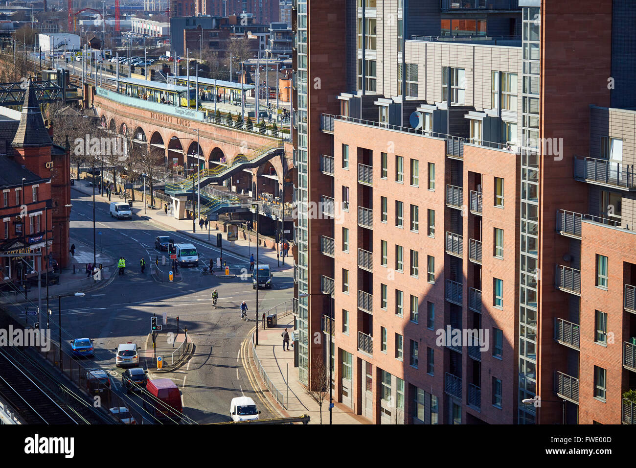 Manchester skyline hacienda apartments and Deansgate Locks with the Metrolink station above busy scene    development Office spa Stock Photo