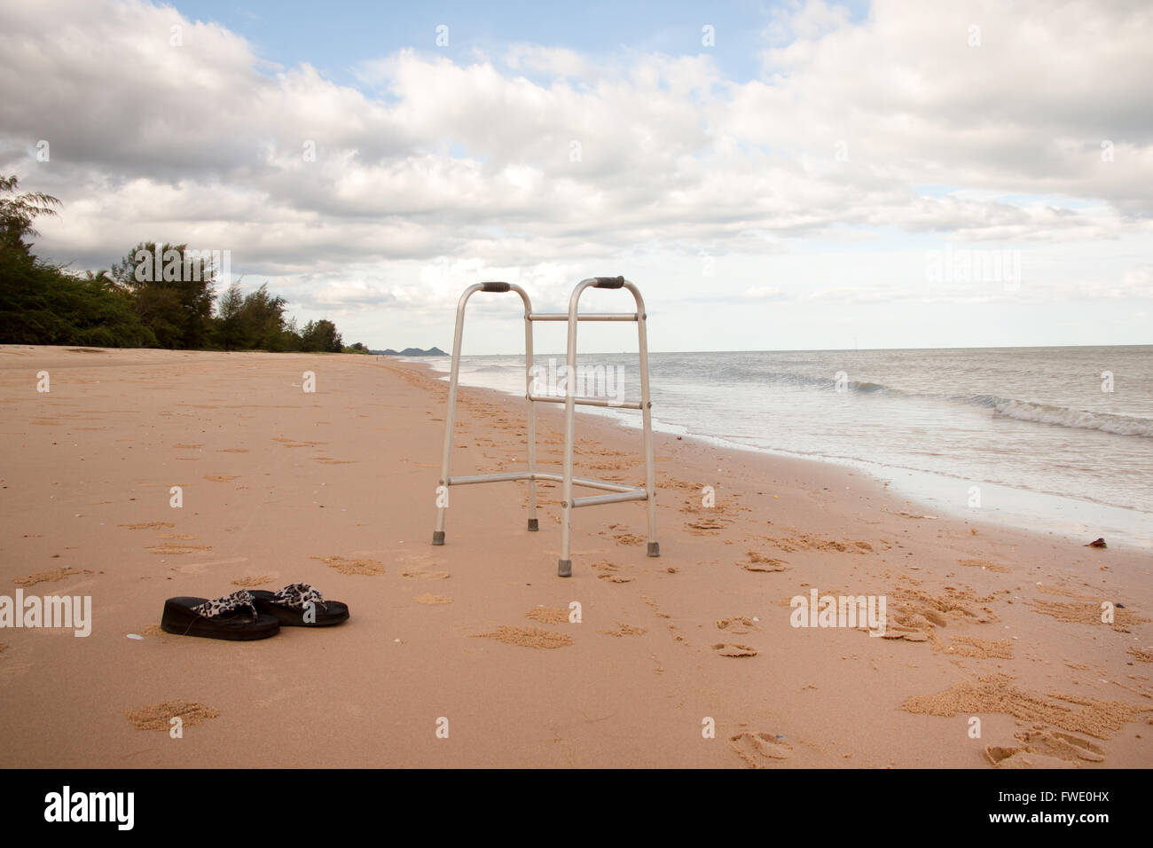 walker on sand beach. convey in meaning the relax tourist attractions of the elderly Stock Photo