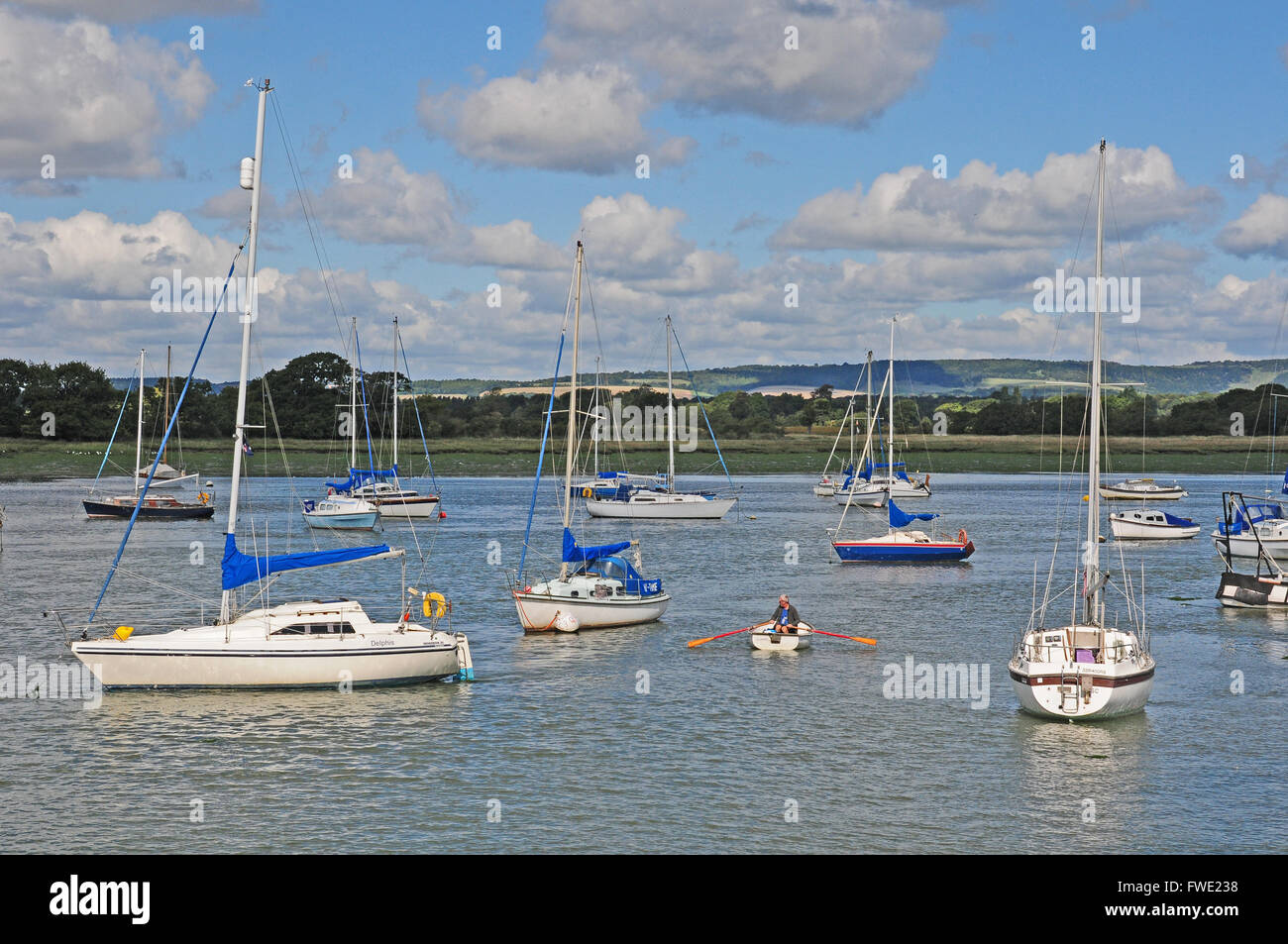 Man rowing out to his dinghy, Dell Quay. Stock Photo