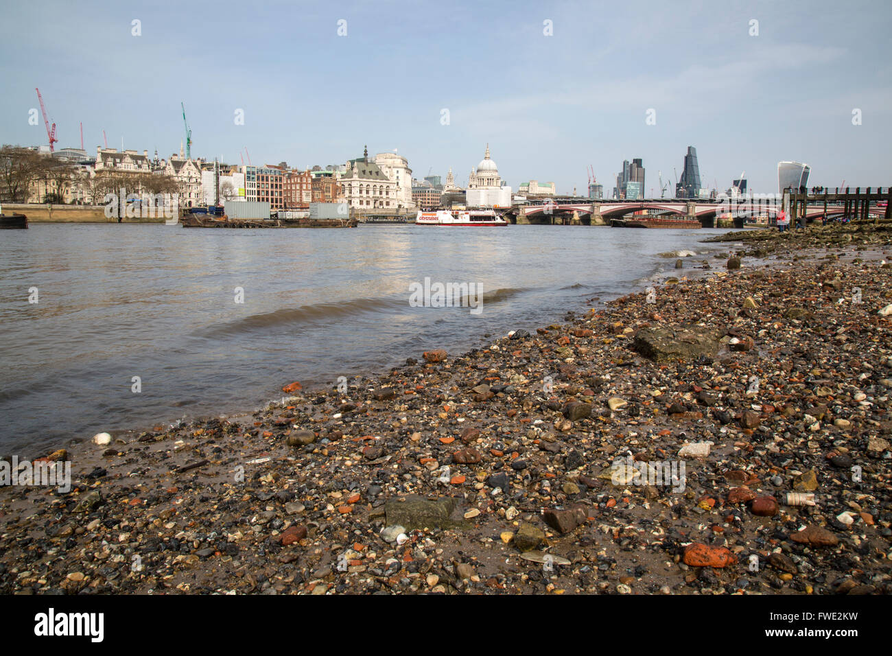 The River Thames foreshore in central London, showing debris from many centuries of trade up and down the river. Stock Photo