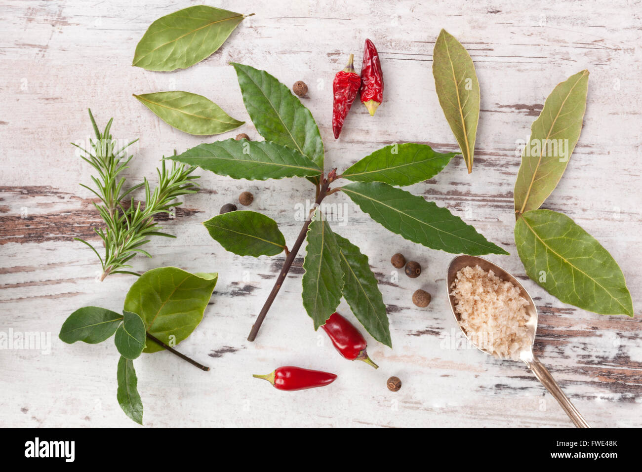 Bay leaves, traditional spice and condiment on white wooden background. Bay leaves, rosemary