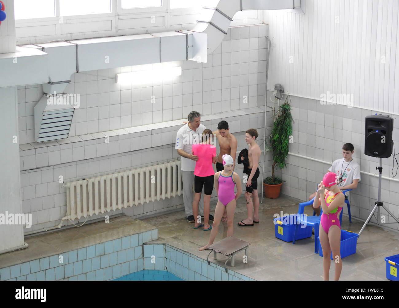 Kovrov, Russia. 28 February 2015. Swimming competition. Coach calms pupil after unsuccessful a swim Stock Photo