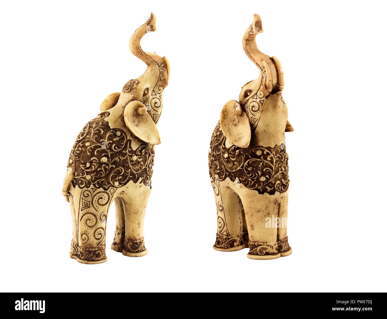 Two carved statuettes of indian elephants  with beautiful ornate pattern. One elephant looks almost in front, another slightly b Stock Photo