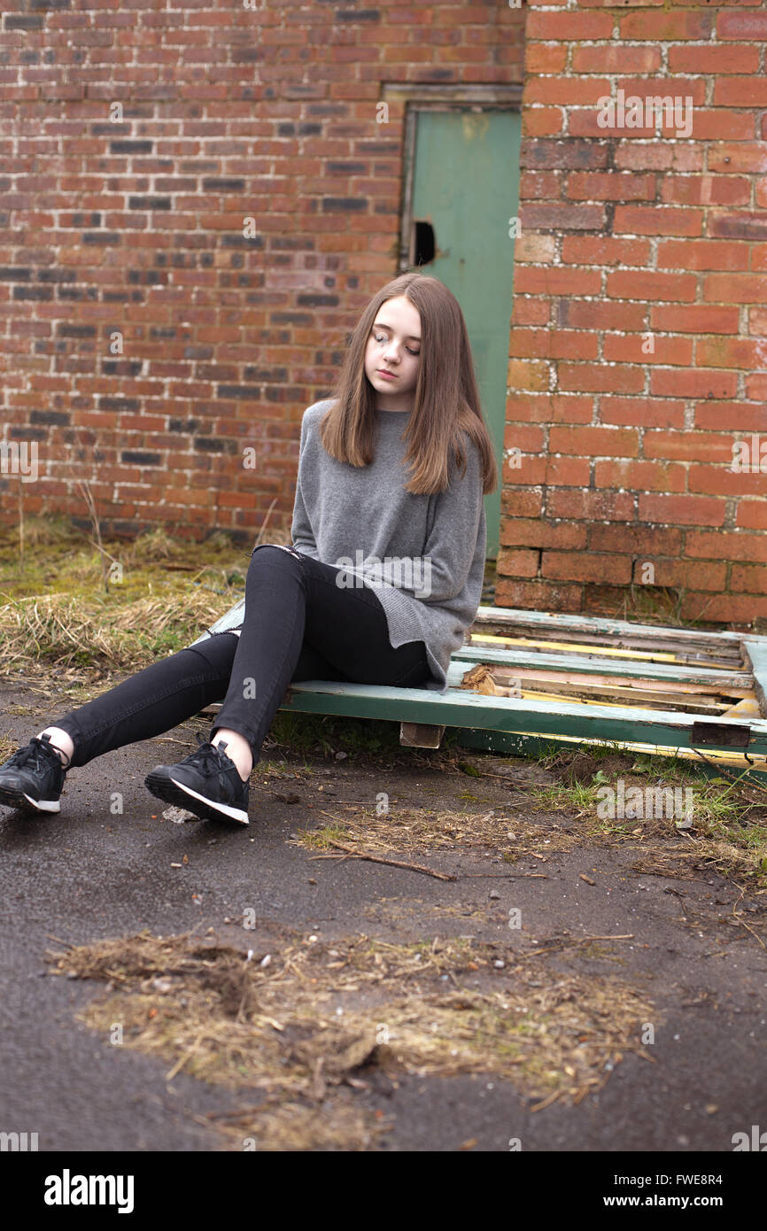 Teen girl sitting sad outside hi-res stock photography and images - Alamy