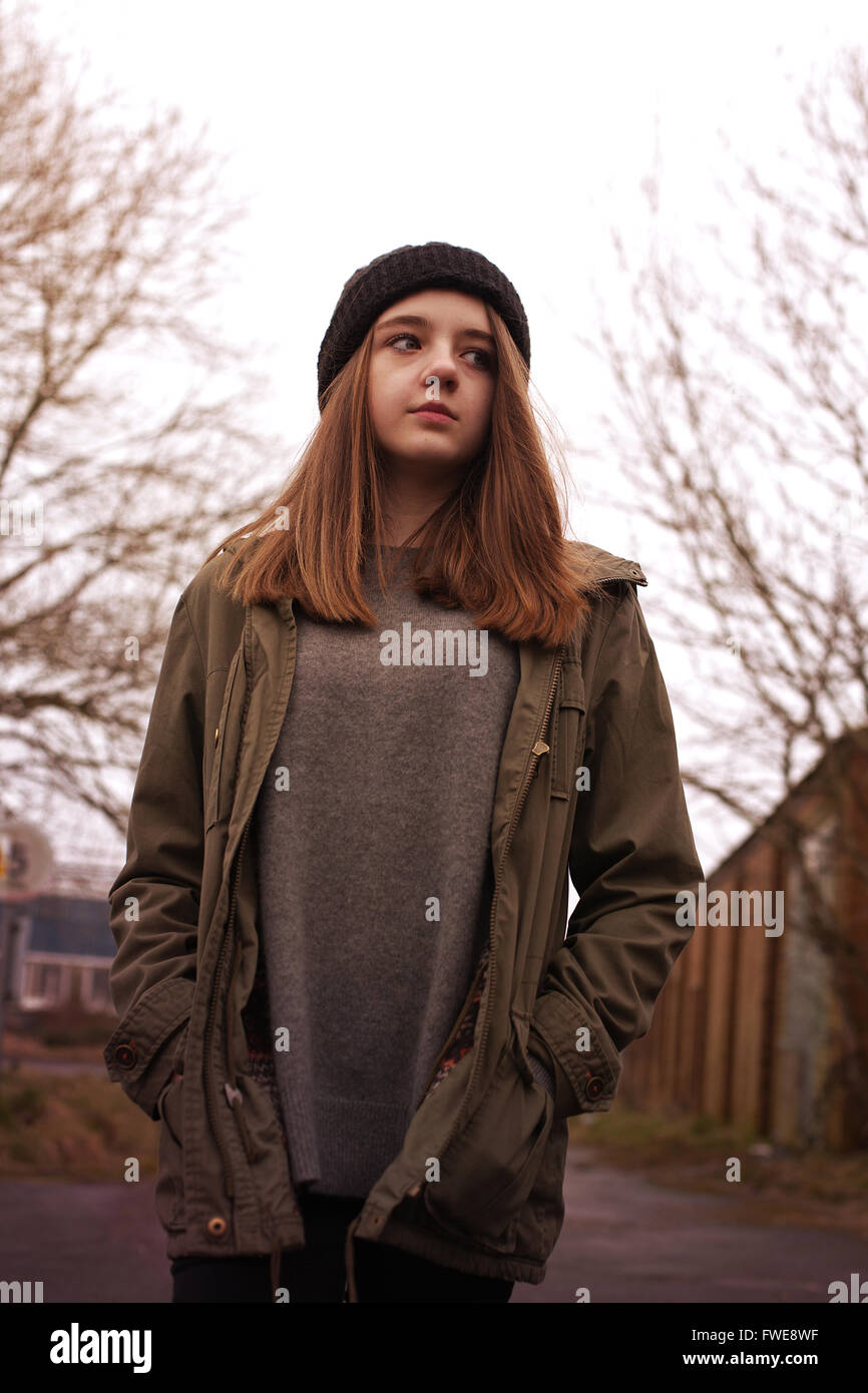 Pretty young teenage girl walking in an urban environment Stock Photo