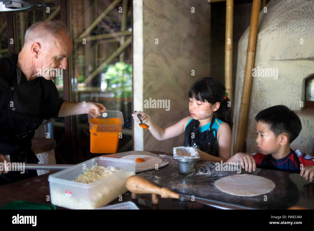 Six Senses Resort, Koh Yao Noi, Phang Nga Bay, Thailand, Asia. Chef and chidren in a cooking class. Six Senses Yao Noi sets the Stock Photo