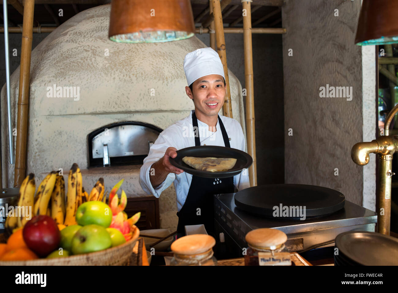 Six Senses Resort, Koh Yao Noi, Phang Nga Bay, Thailand, Asia. Waiter with a pancake in a breakfast time. Six Senses Yao Noi set Stock Photo