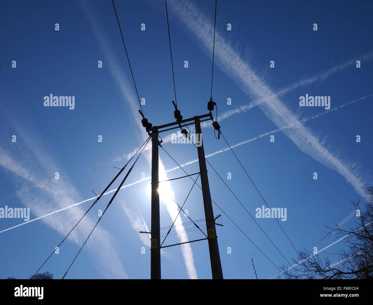 electricity pylon with blue sky plane trails in the countryside Stock ...