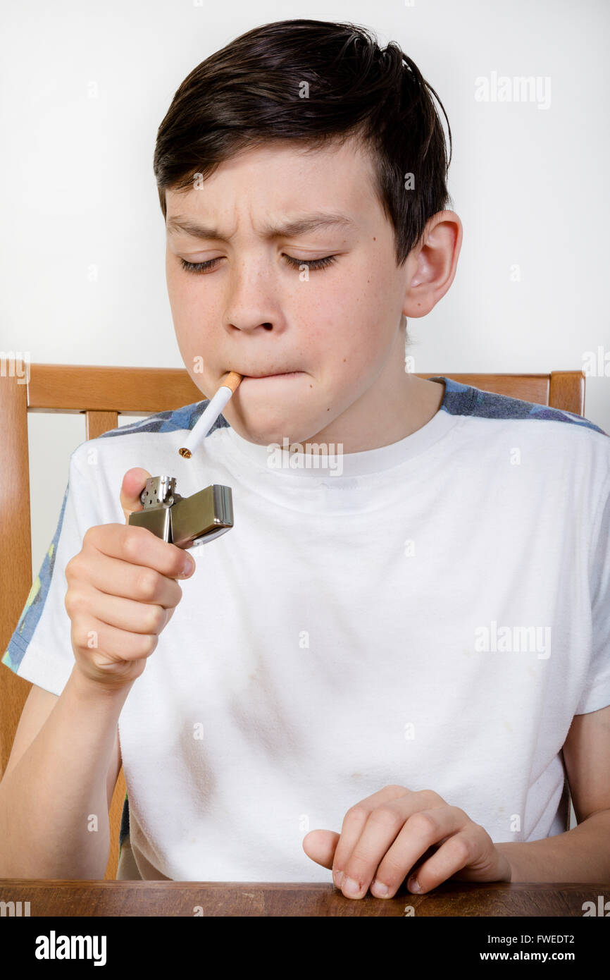Young boy lighting a cigarette with a lighter Stock Photo Alamy