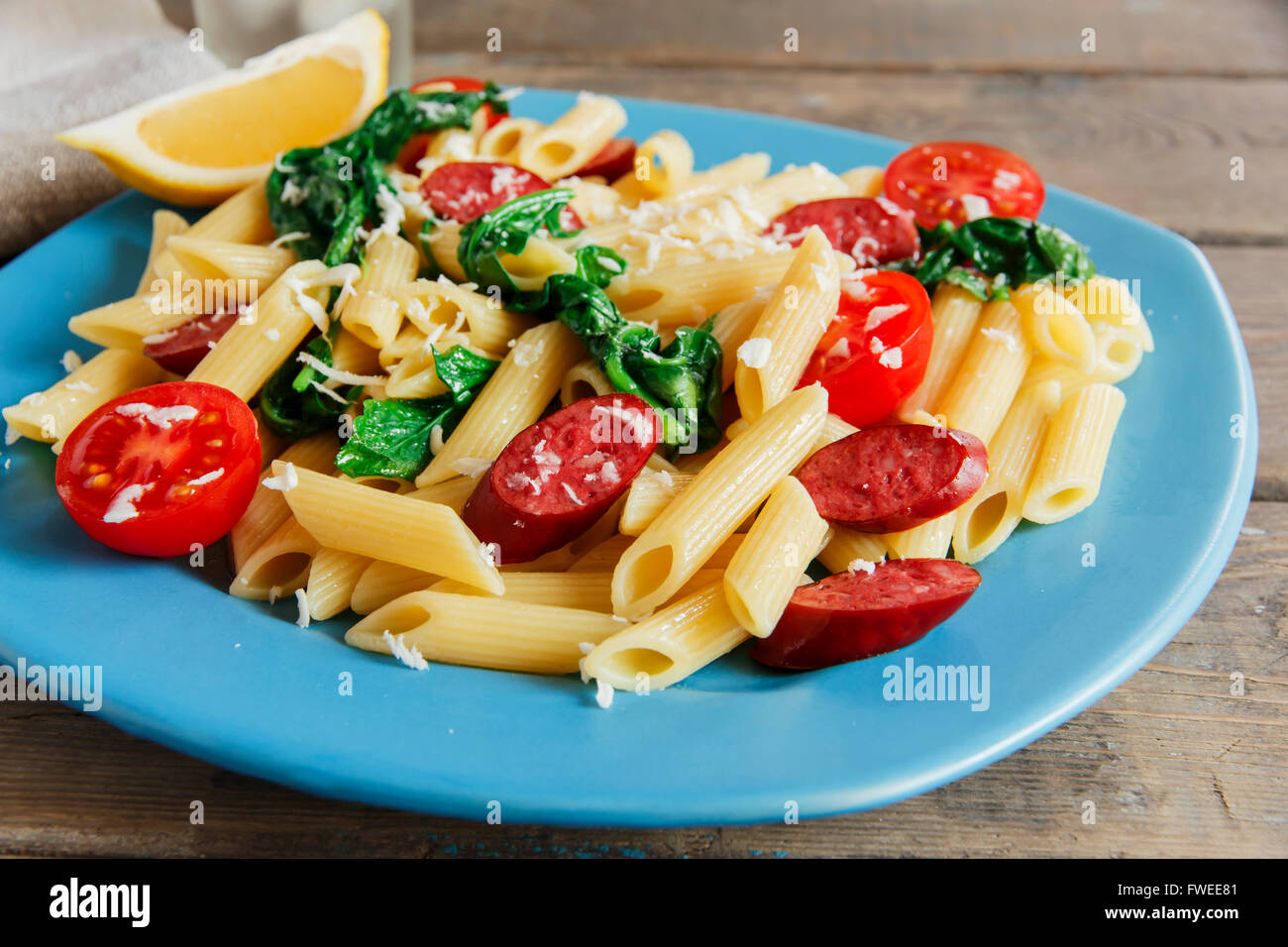 pasta with sausage spinach tomato and cheese Stock Photo