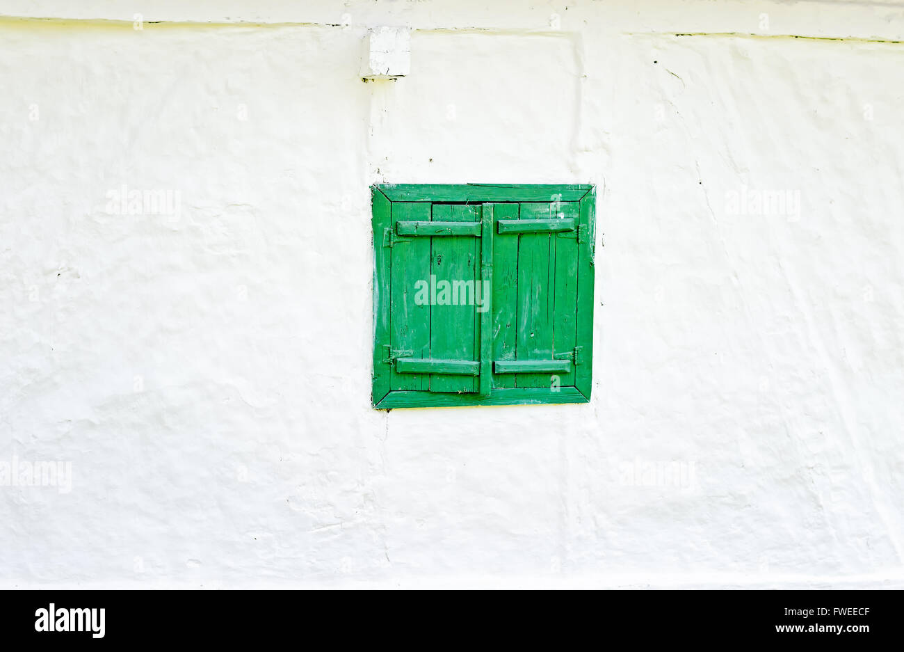 Closed green wooden window shutters on an old whitewashed wall Stock ...