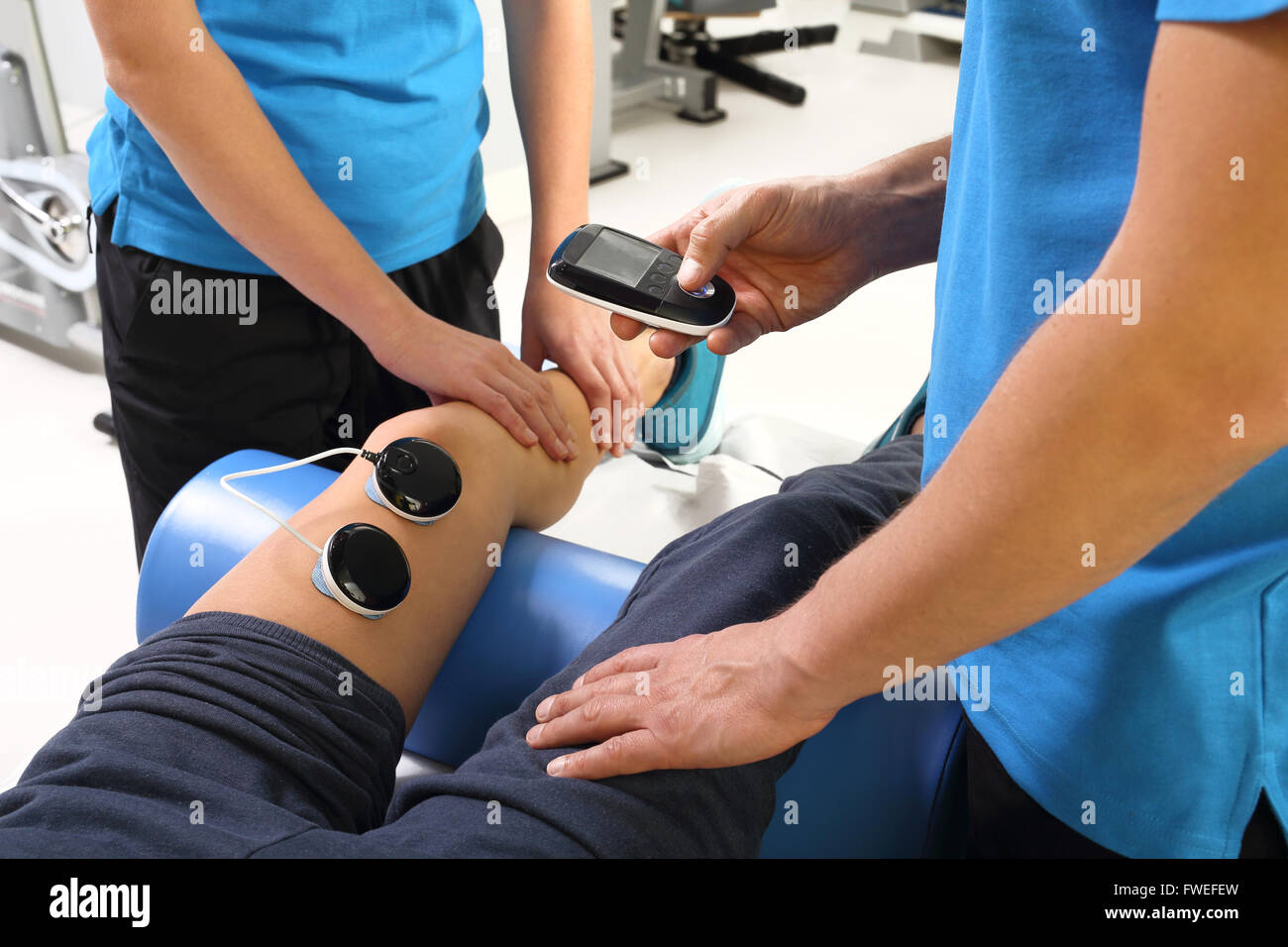 Patient having electrode therapy, or electrical muscle stimulation, on a  knee joint using electrical stimulation to treat muscle pain and prevent  atro Stock Photo - Alamy