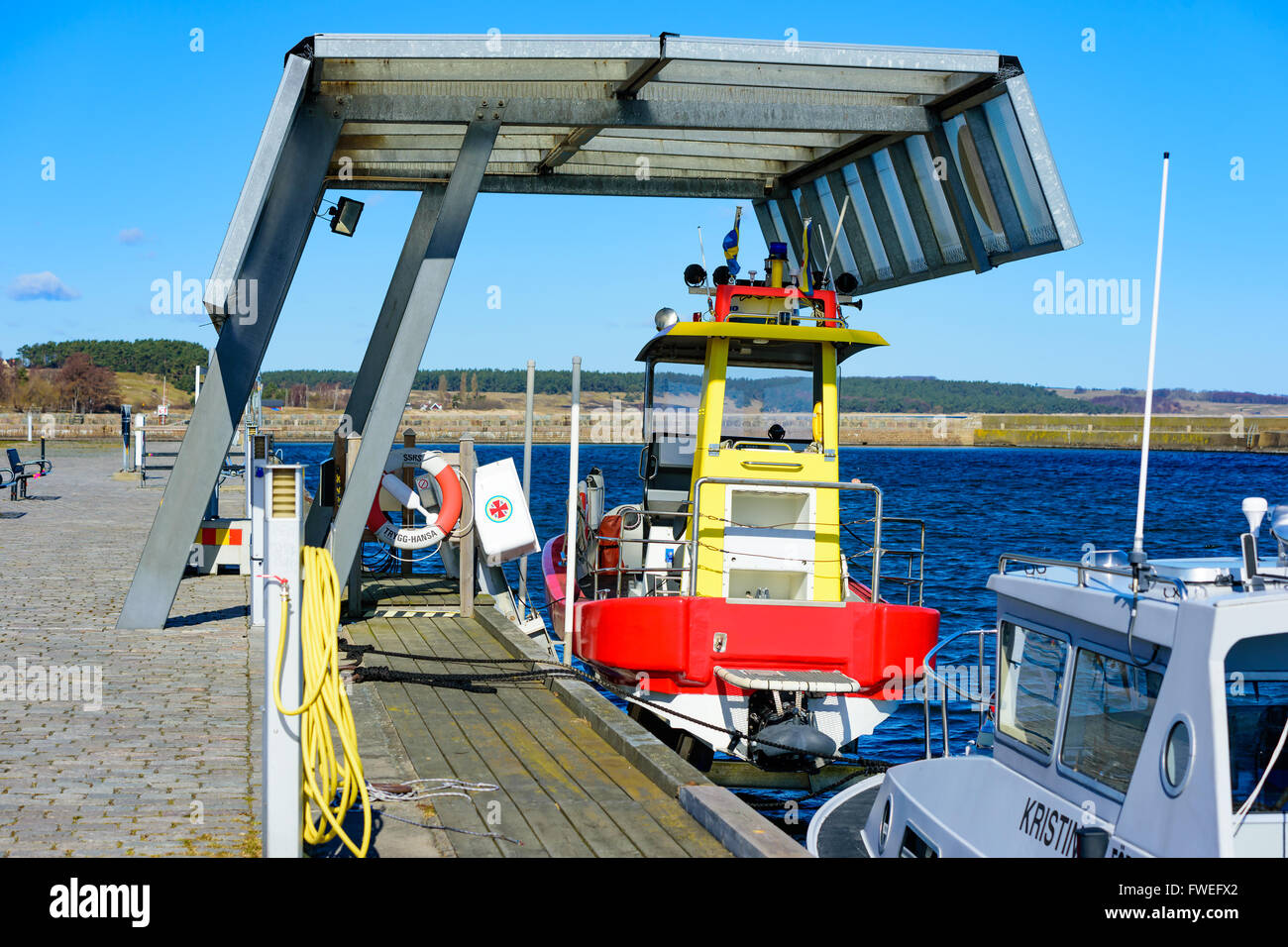 Kivik, Sweden - April 1, 2016: The Swedish Sea Rescue Society search and rescue boat moored or rather hoisted under a shelter in Stock Photo