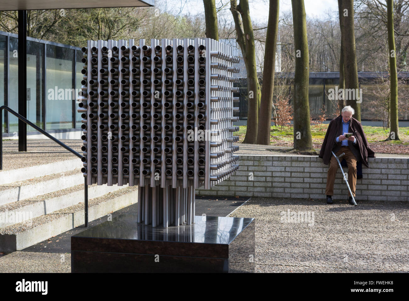 Man viewing a sculpture by André Volten at the Kröller-Müller Museum in the Hoge Veluwe National Park, Netherlands Stock Photo