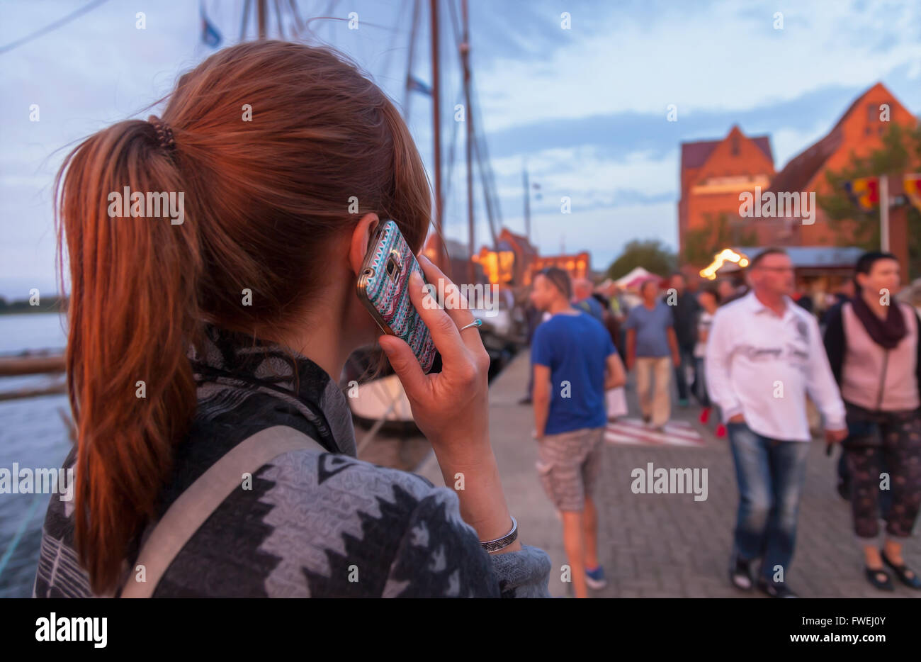 telephoning woman with mobile phone in germany Stock Photo