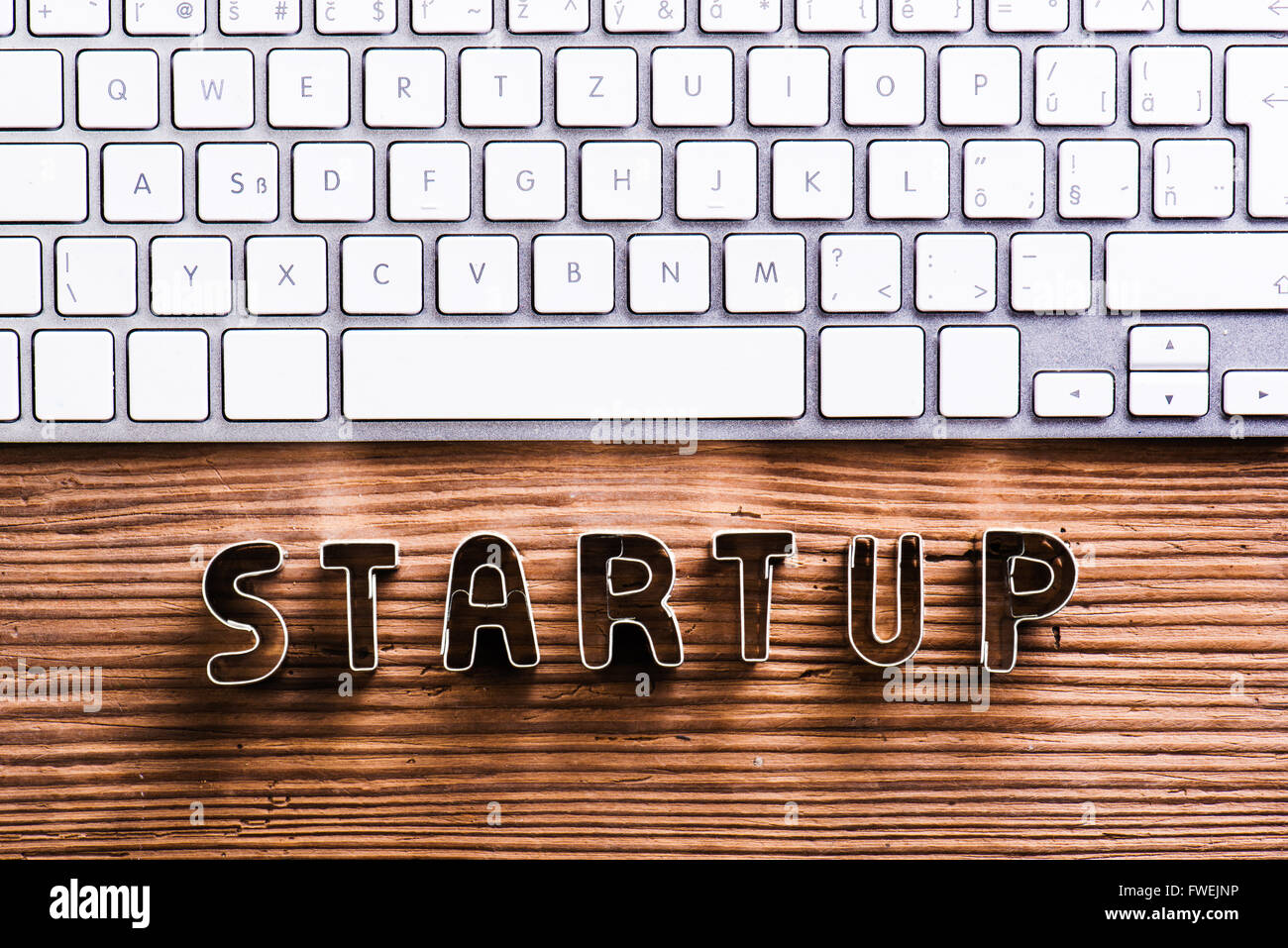 Office desk with start up sign and computer keyboard Stock Photo - Alamy