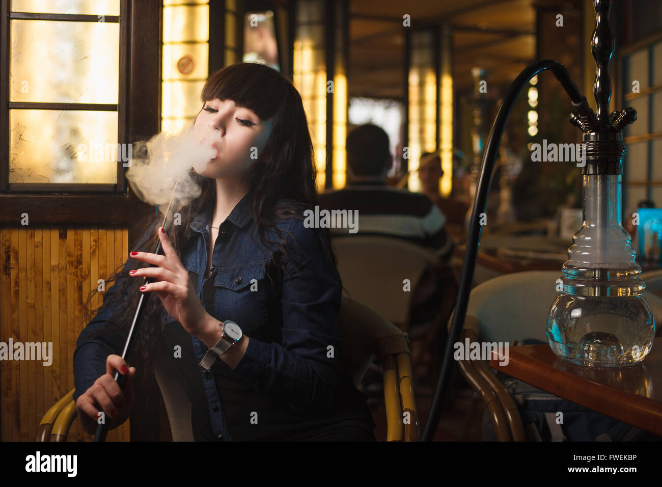 Beautiful young woman with hookah Stock Photo