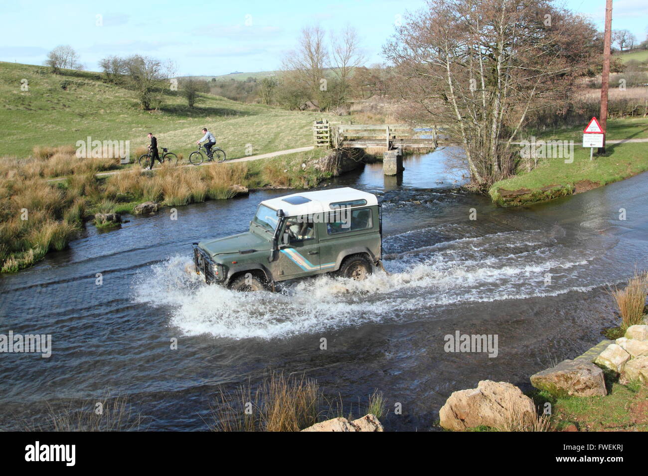 A 4x4 vehicle crosses the ford at Tissington in the Derbyshire Dales, England UK Stock Photo