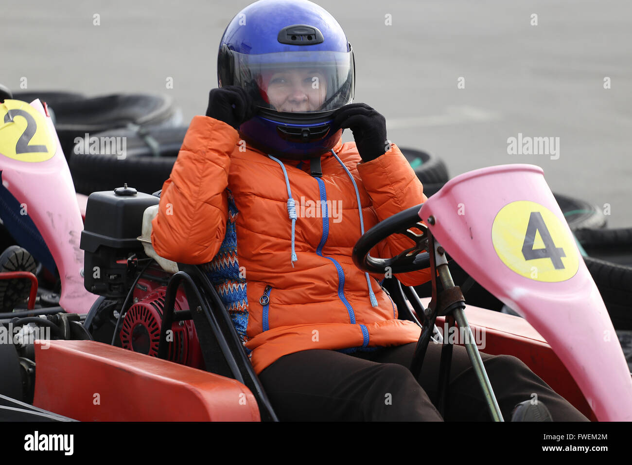 girl is driving Gokart car with speed in a playground racing track. Go kart is a popular
