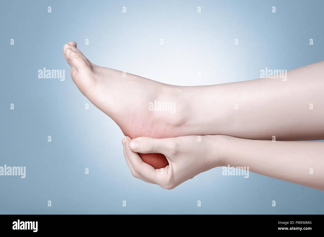 A young woman massaging her painful heel Stock Photo