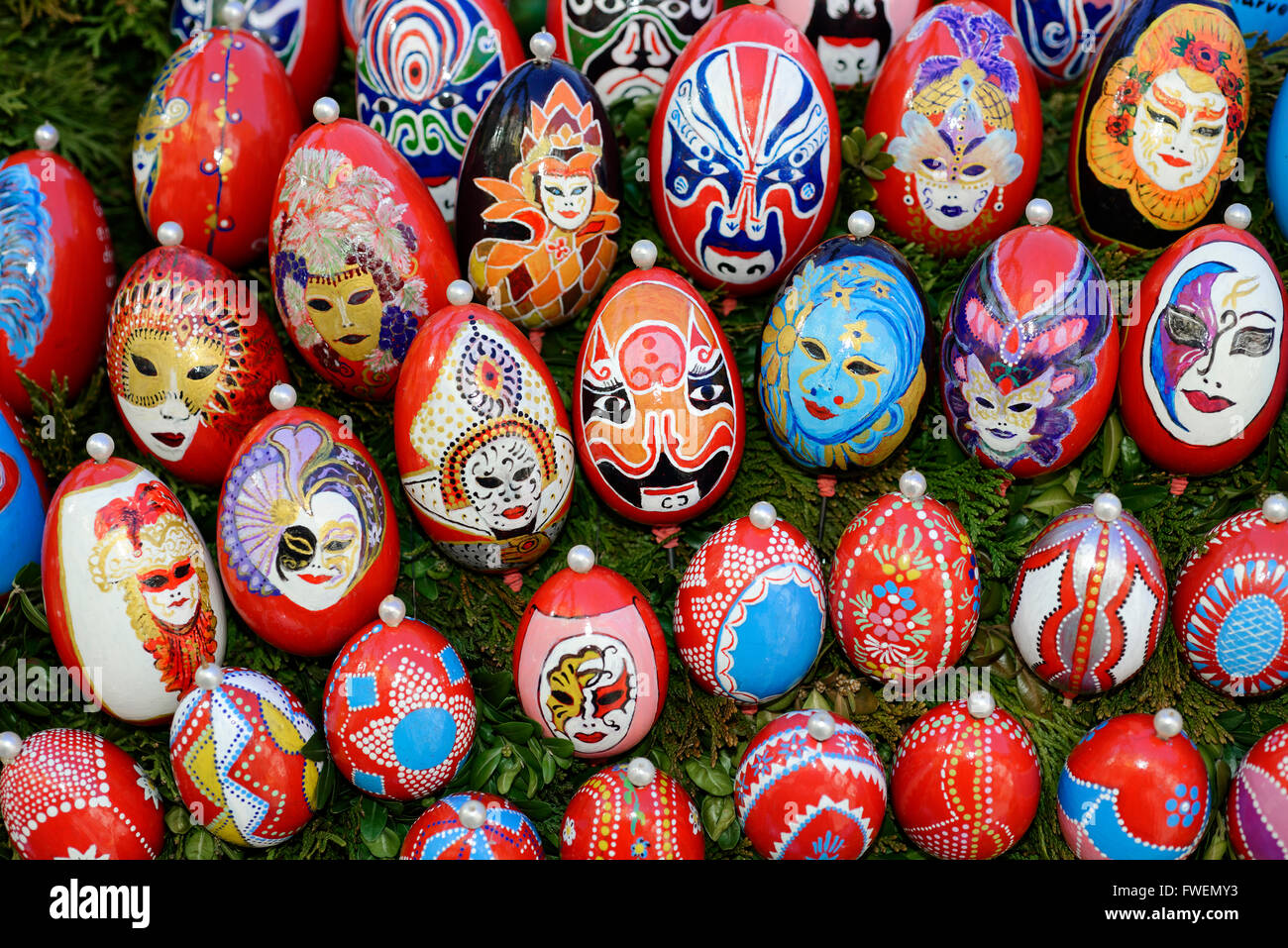 Painted Easter eggs with carnival masks on an Easter well, Osterbrunnen, Schechingen, Baden-Württemberg, Germany Stock Photo