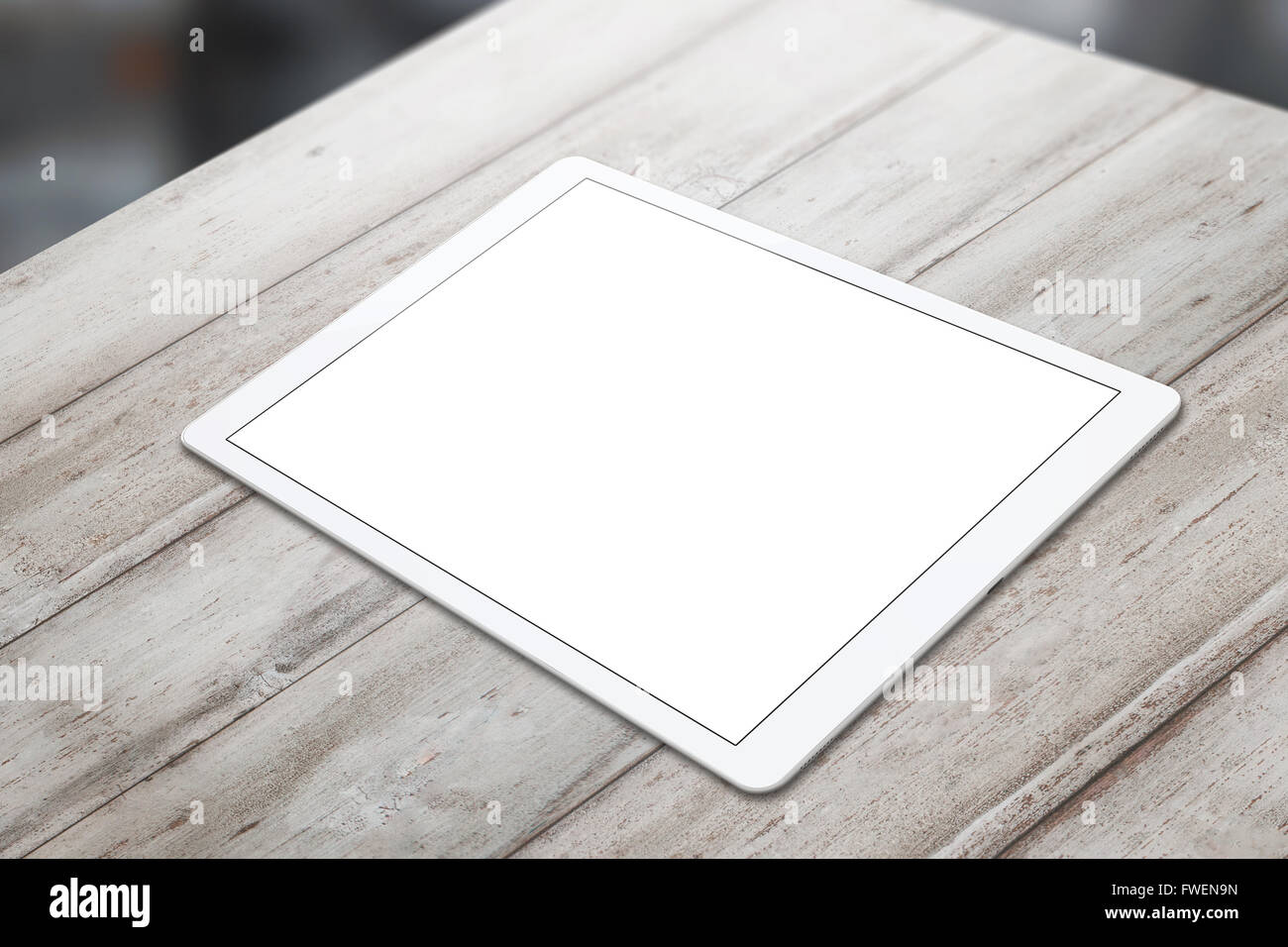 White tablet on wooden table with isolated white screen for mockup