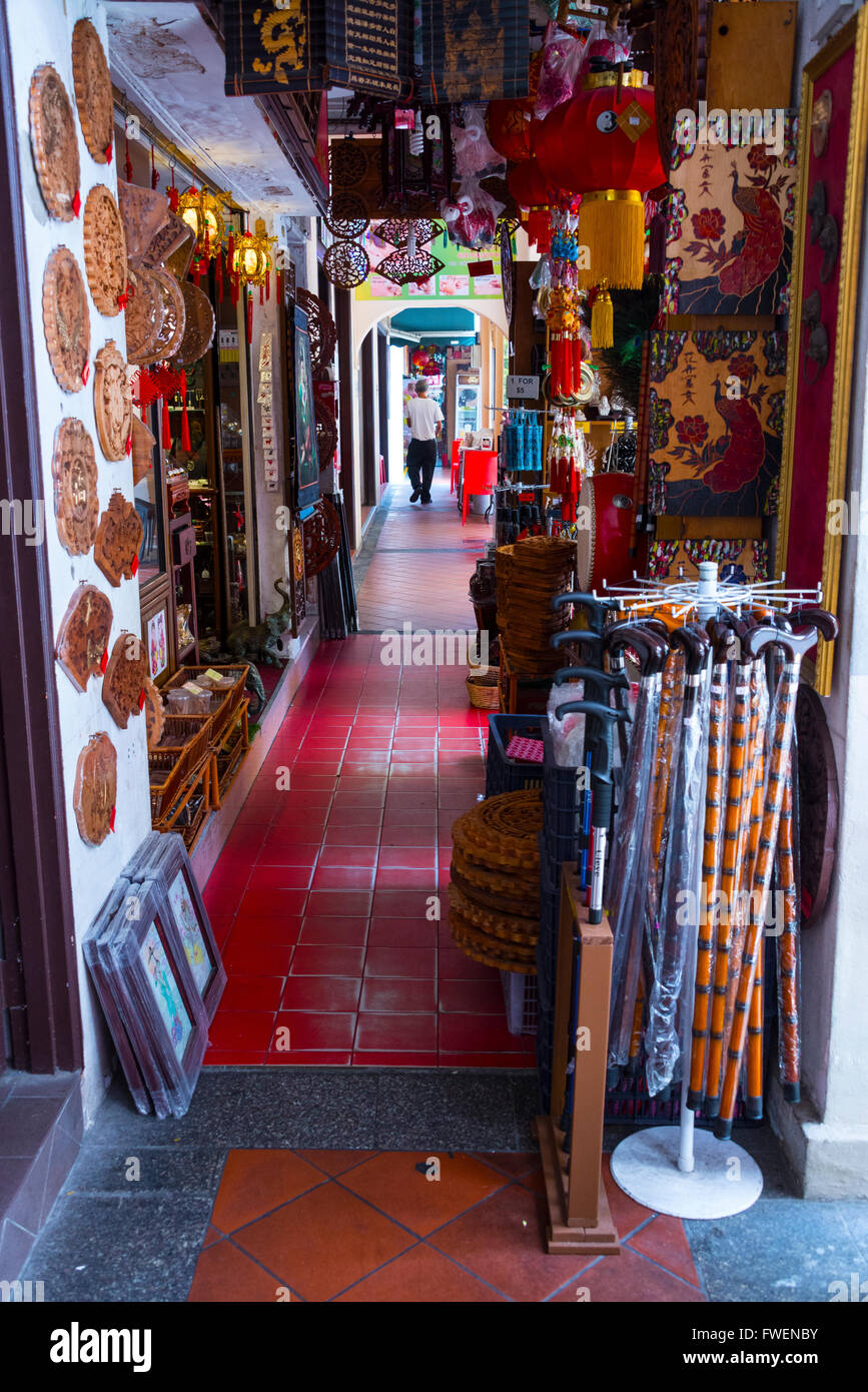 A narrow archway with rows of small shops lined with a variety of