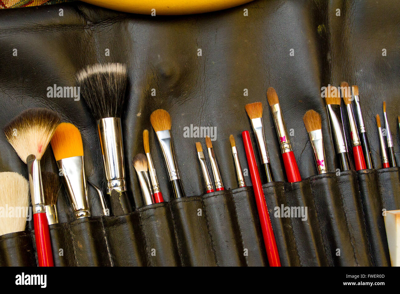 Makeup brushes in a container for wedding makeup and styling. Stock Photo