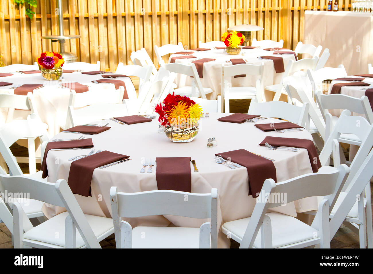 Place settings, tables, and chairs are empty before the guests arrive