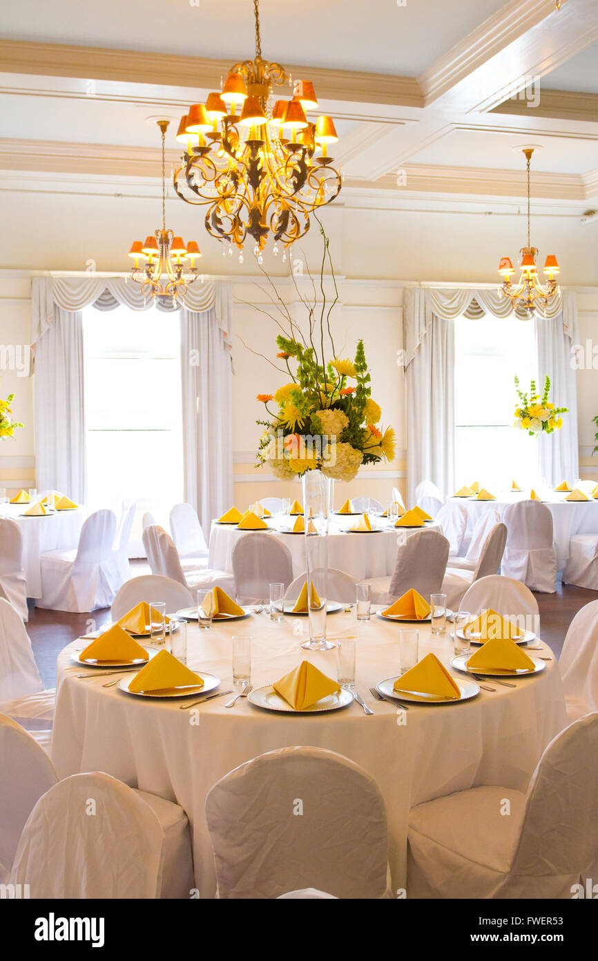 Place settings, tables, and chairs are empty before the guests arrive