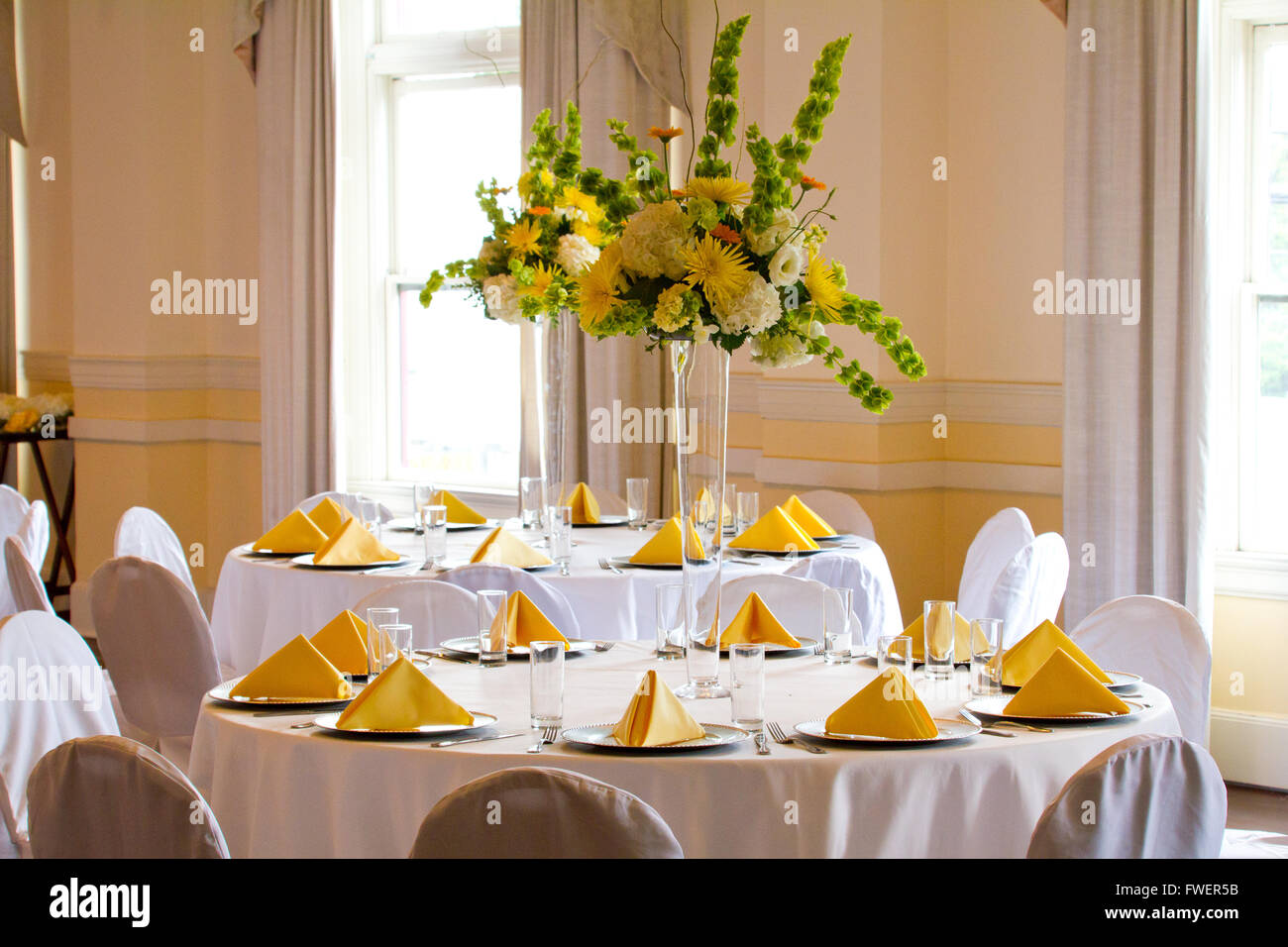 Place settings, tables, and chairs are empty before the guests arrive