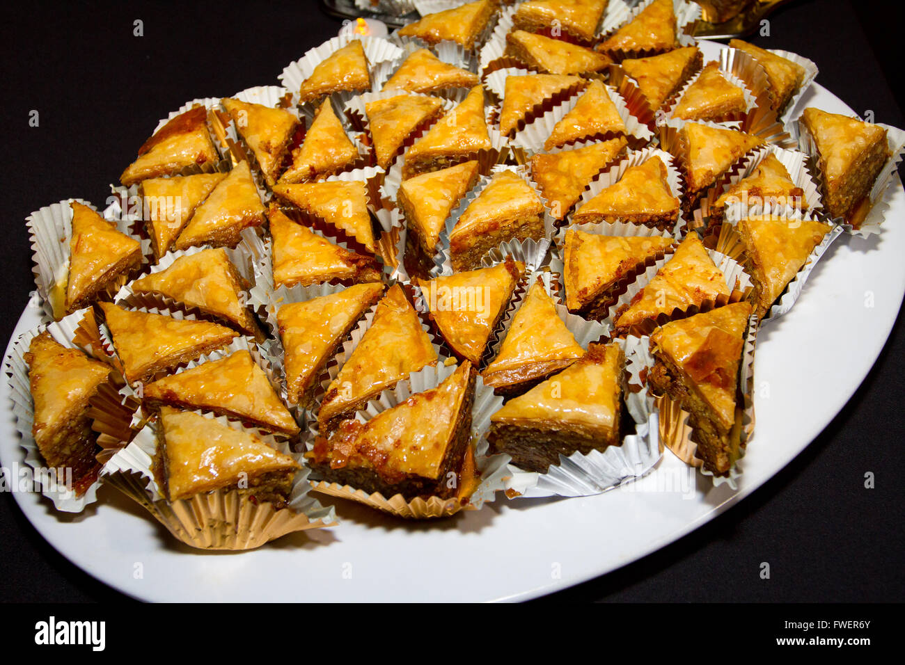 The Greek dessert baklava is individually wrapped and set on a platter at a wedding reception. Stock Photo
