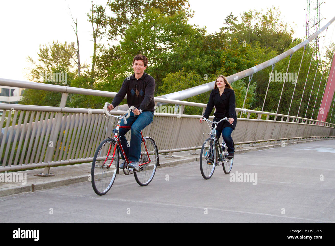 A married man and woman with their bikes on a bicycle path bridge Stock ...
