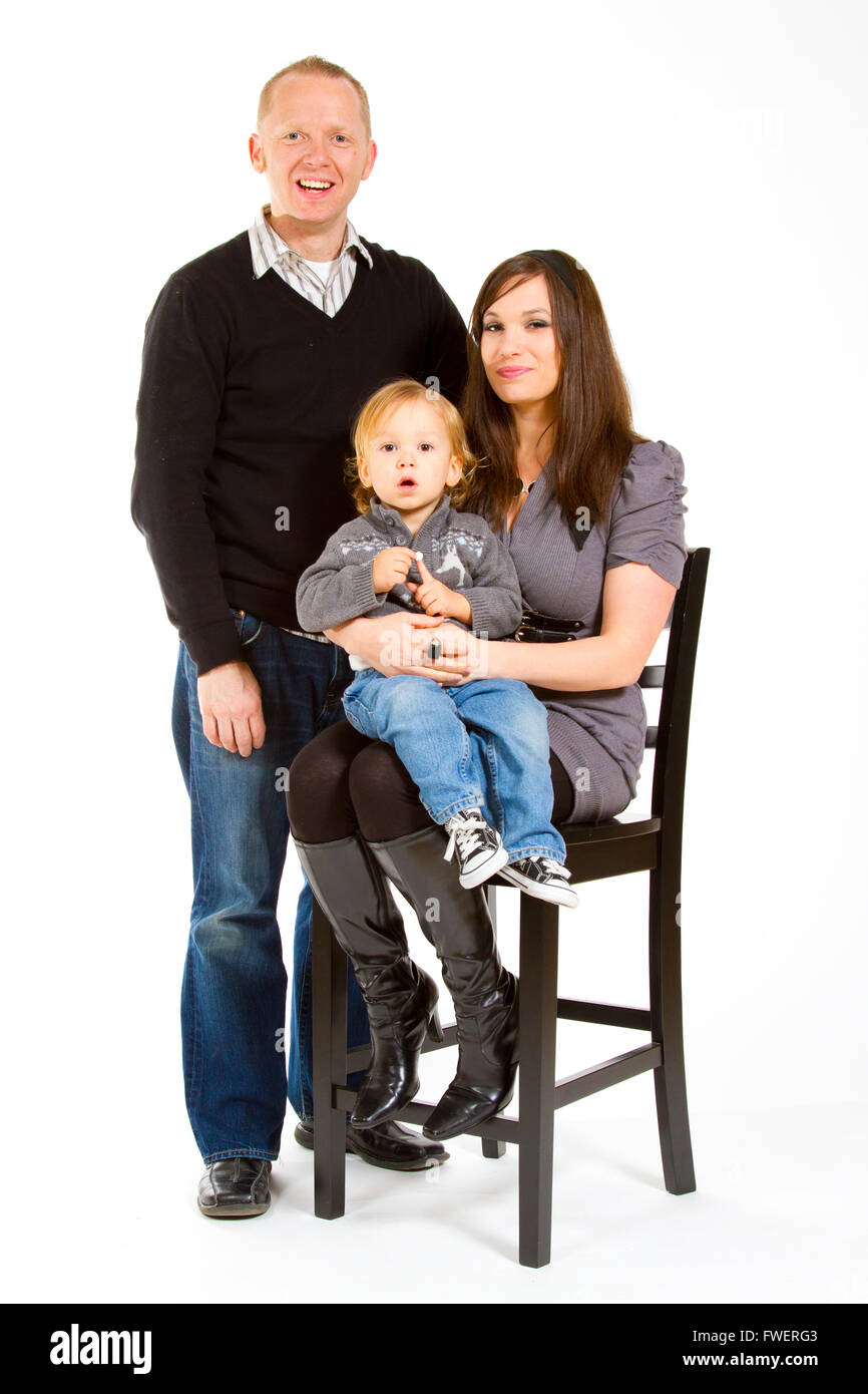 A small family of three portrait in a studio with a white background. Stock Photo