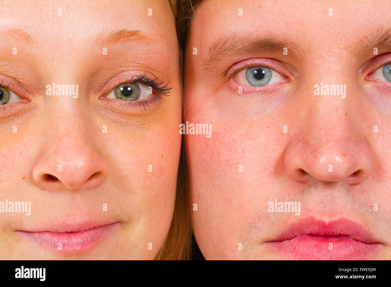 An attractive couple is photographed for a studio portrait on a white background. Stock Photo