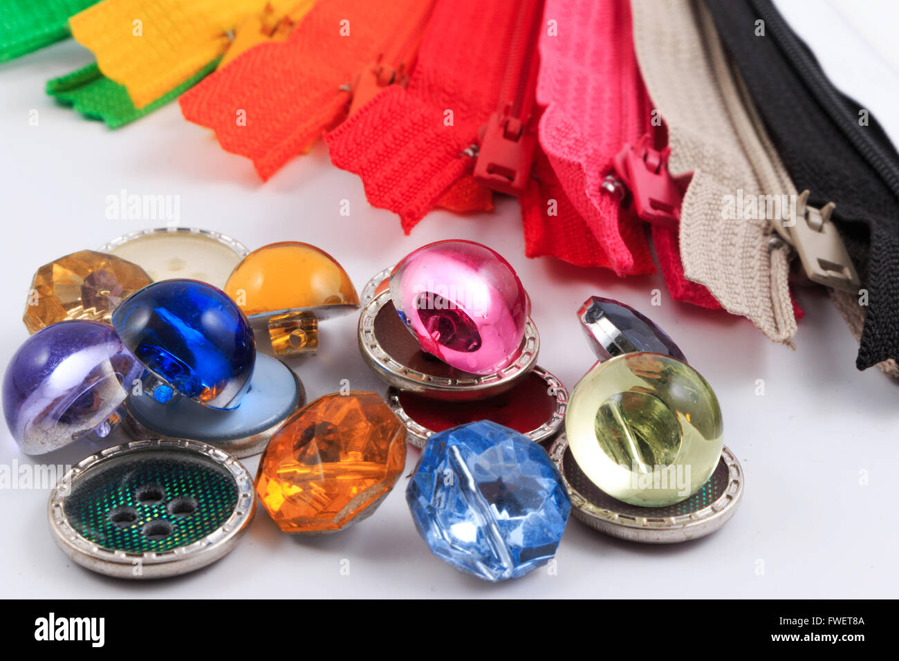 Colorful zippers and buttons on white background Stock Photo Alamy