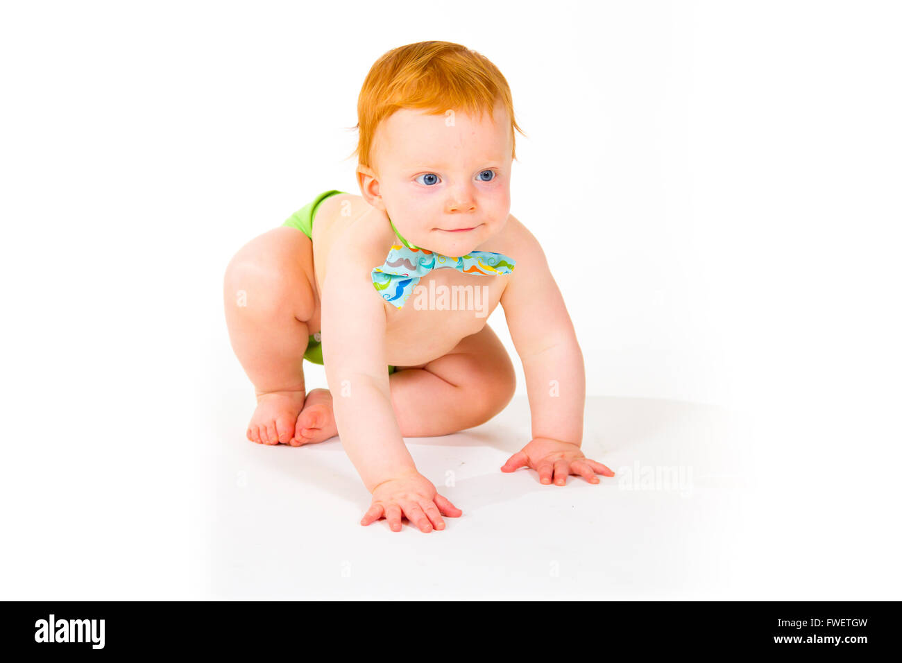 A one year old baby boy in the studio with a white background. The kid