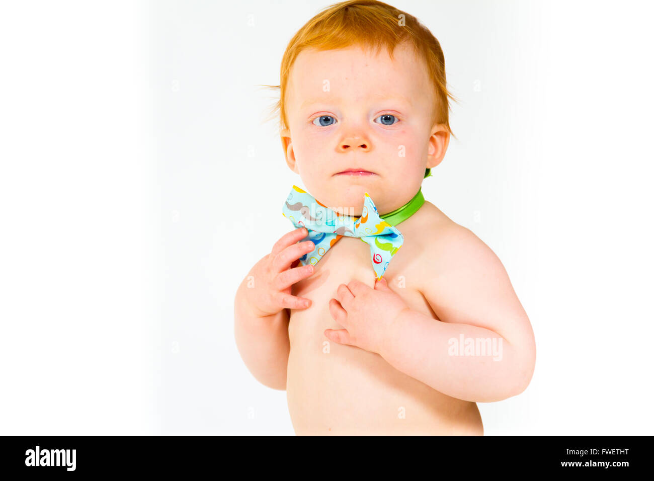 A one year old baby boy in the studio with a white background. The kid