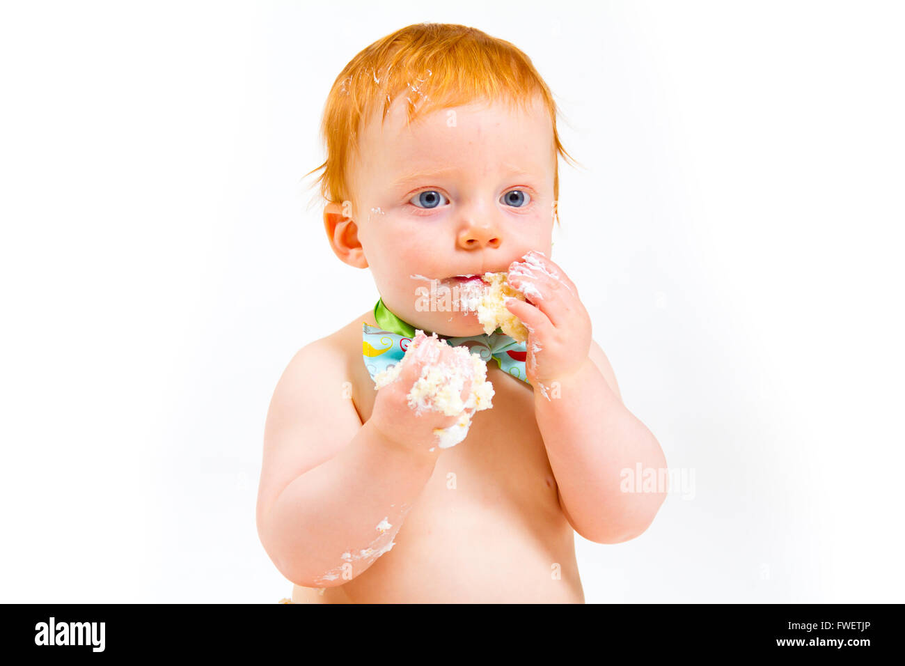 A baby boy gets to eat cake for the first time on his first birthday in this cake smash in