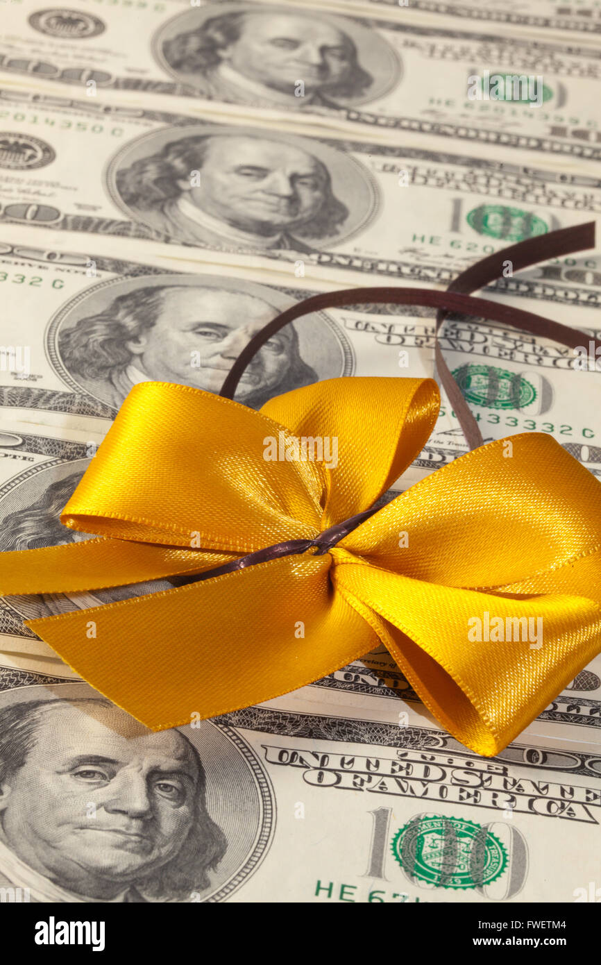 Packs of dollar bills with gold bow Stock Photo