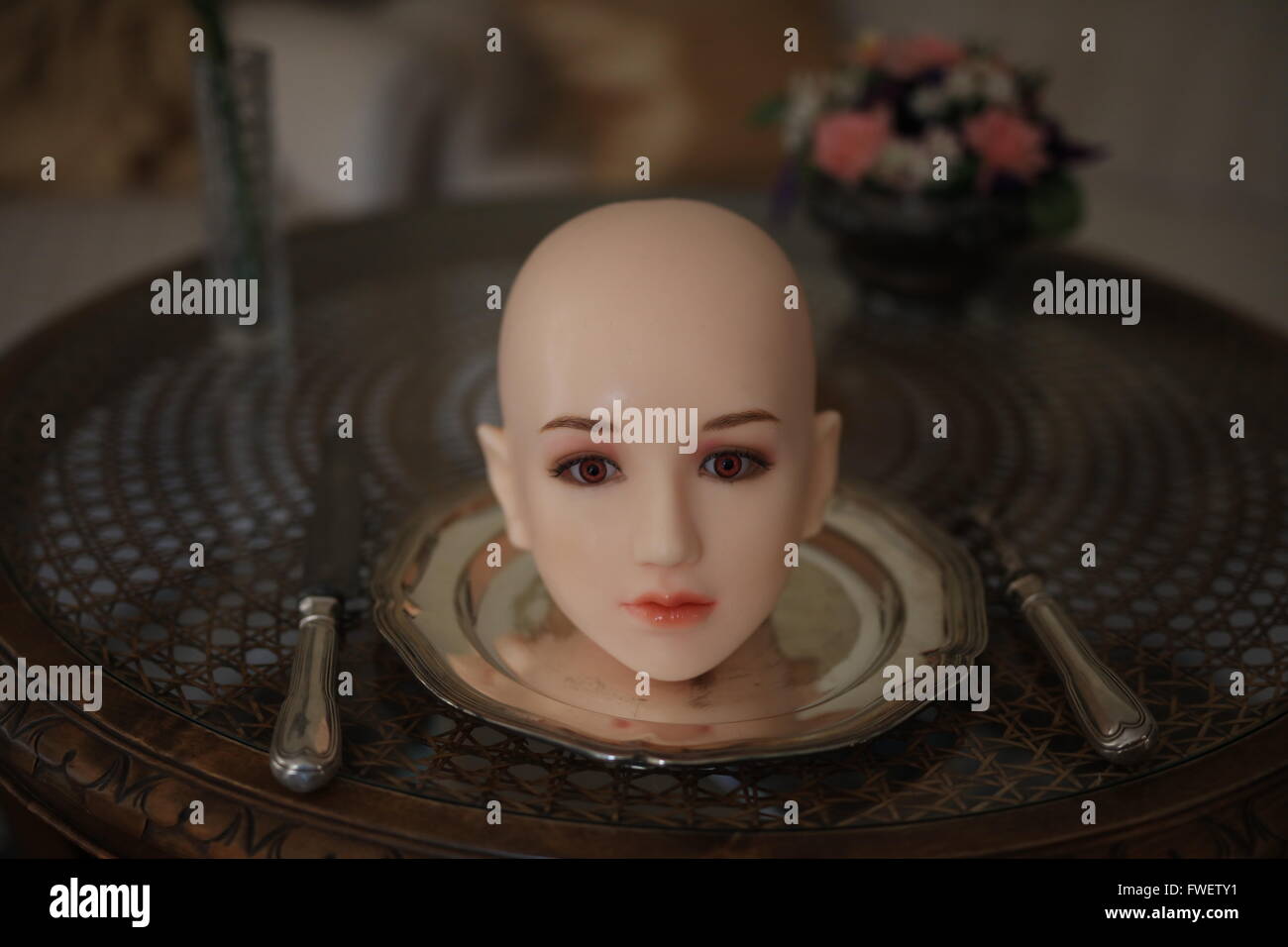 Bald head on a silver plate with cutlery Stock Photo