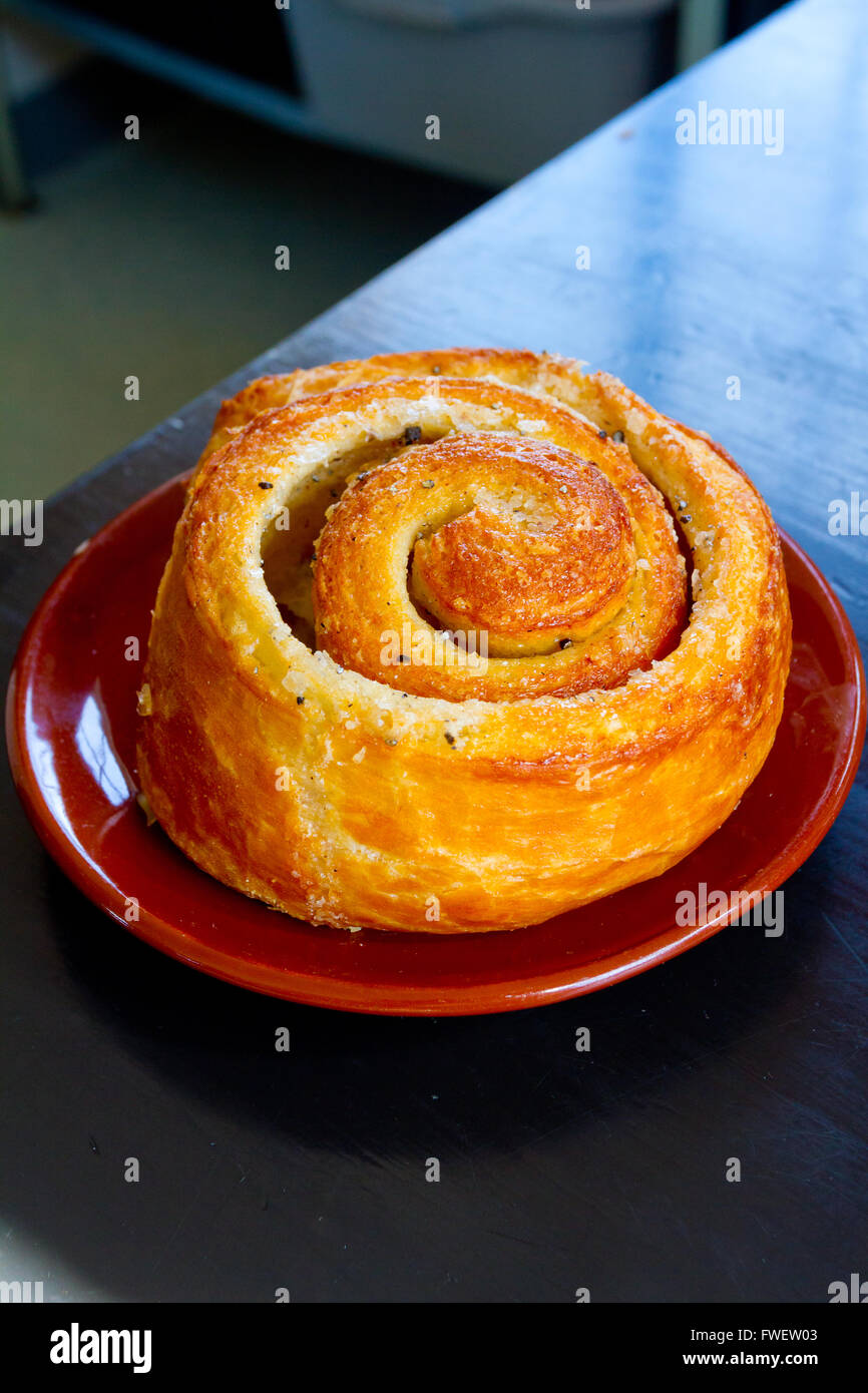 A morning bun cinnamon roll on a plate at a cafe restaurant Stock Photo Alamy