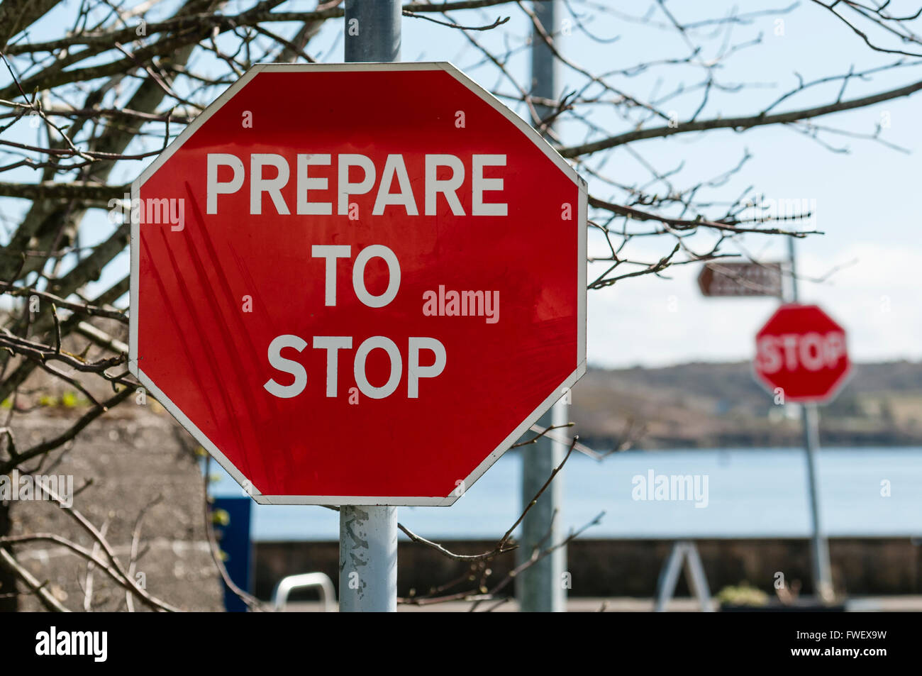 Sign at a stop junction in Ireland saying 'Prepare to Stop', followed by a Stop sign. Stock Photo